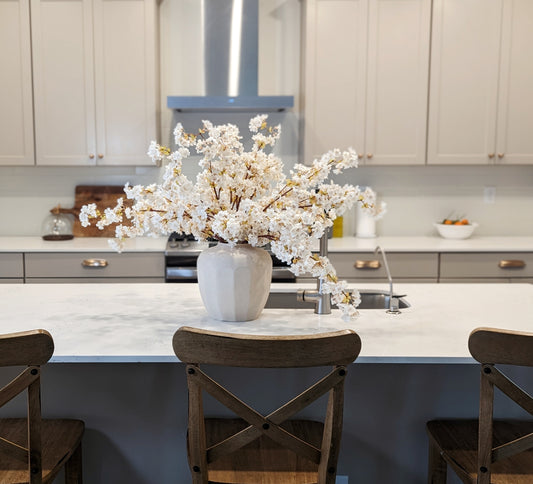 Picture of a kitchen with mixed metals and woods. 