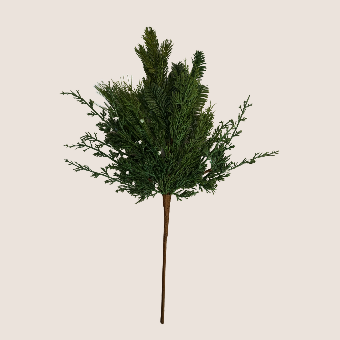 Single stem of mixed evergreen artificial stem featuring mix of juniper, cedar, balsam fir, and ponderosa pine against blush background.