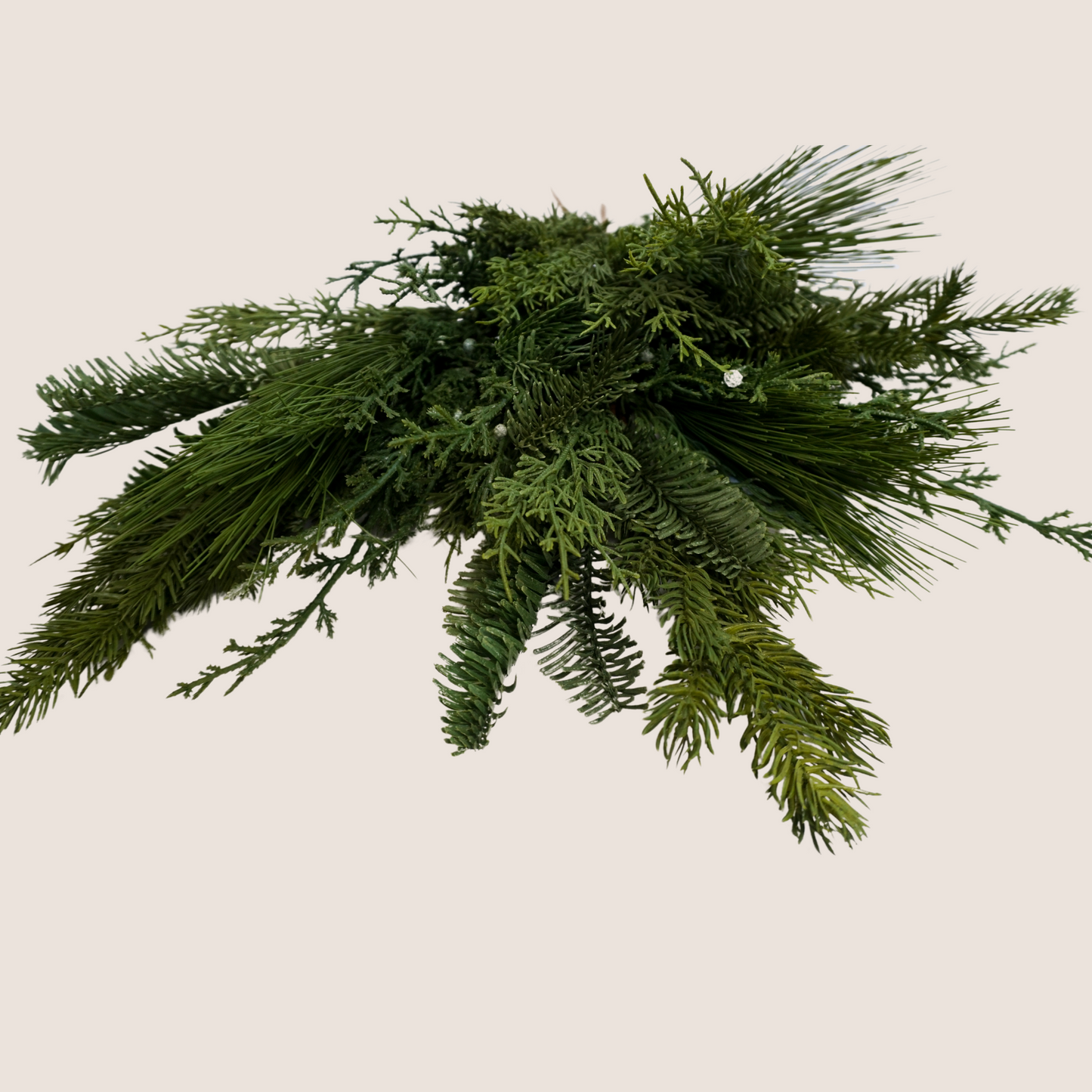 Direct head-on photo of set of 3 mixed evergreen artificial stems featuring mix of juniper, cedar, balsam fir, and ponderosa pine against blush background.