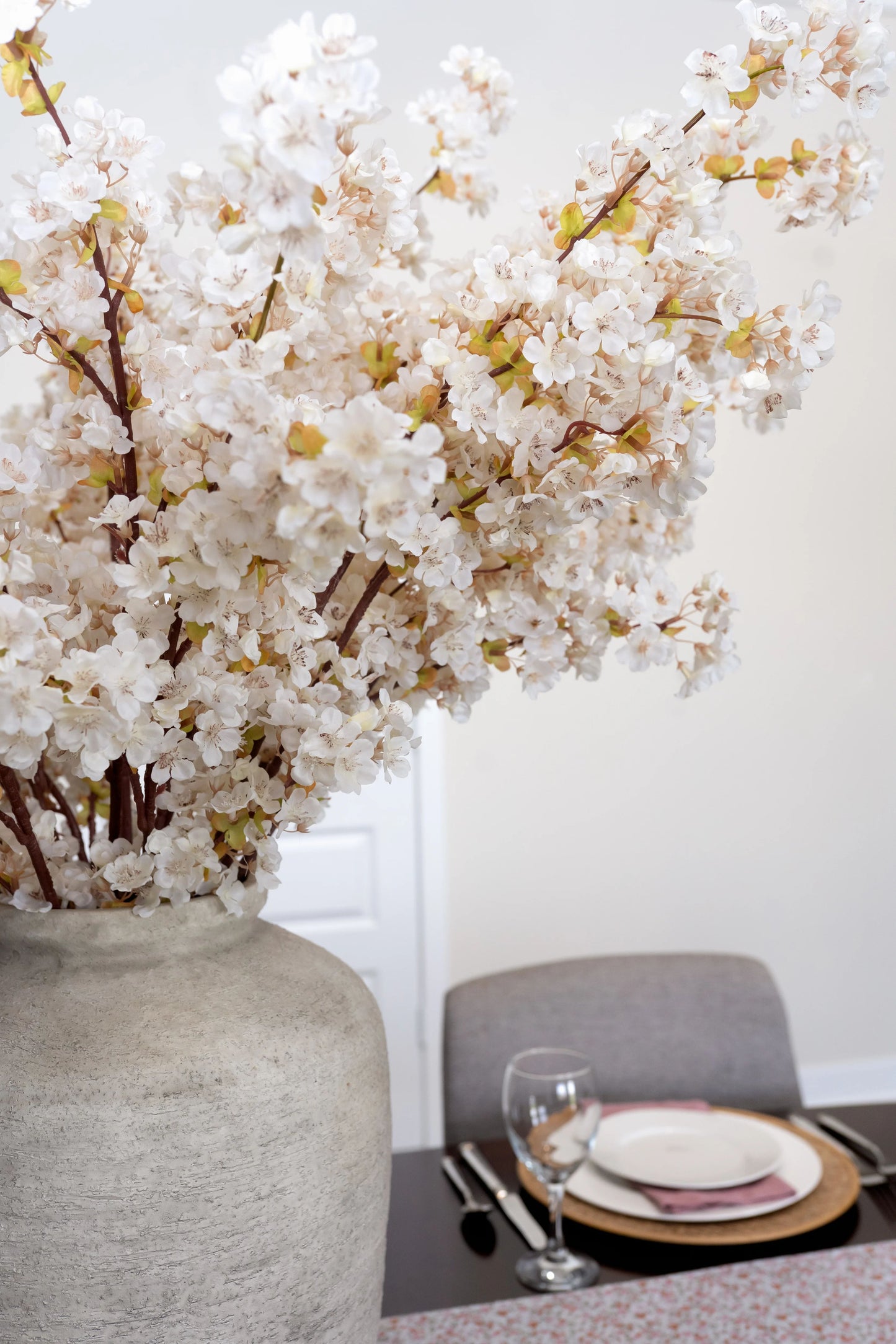 Close up of artificial cherry blossom flower stems with the most lifelike faux blossoms.