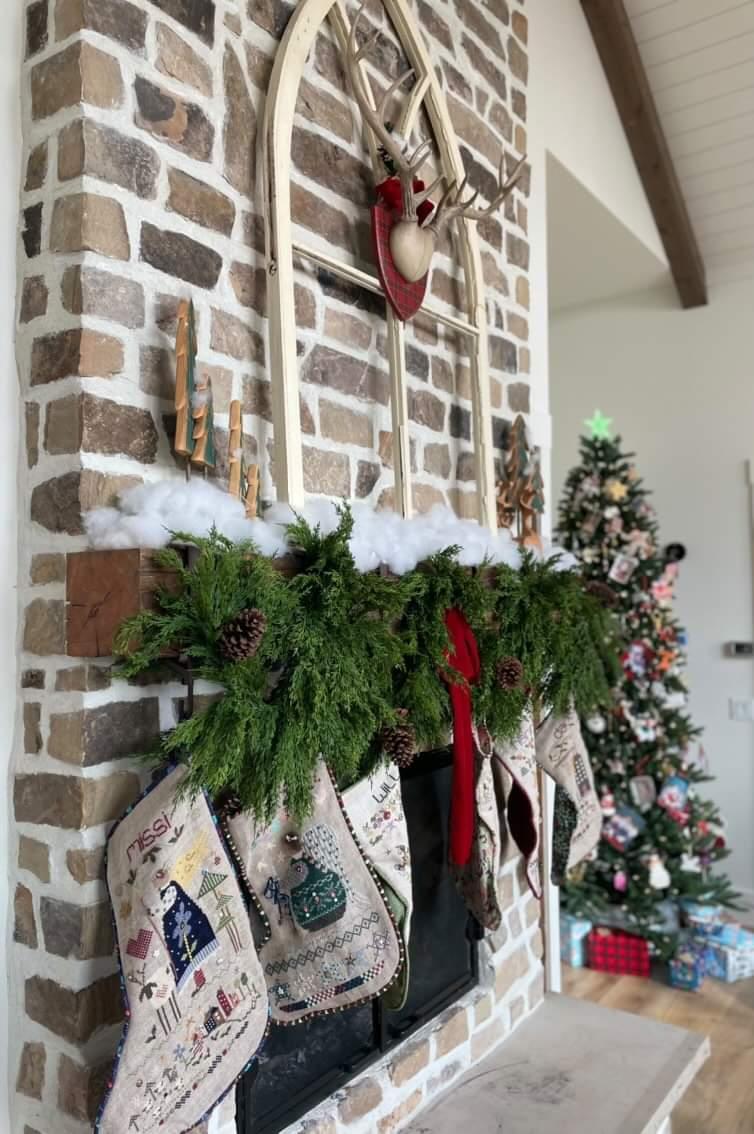 Artificial cedar holiday garland on Christmas mantle.