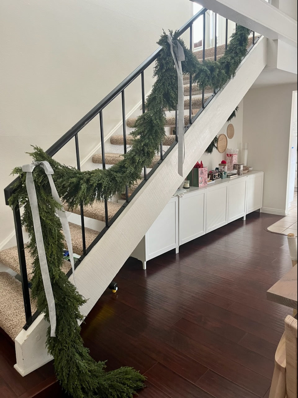 9 foot artificial cedar garland on stair case in California style home for the holiday.