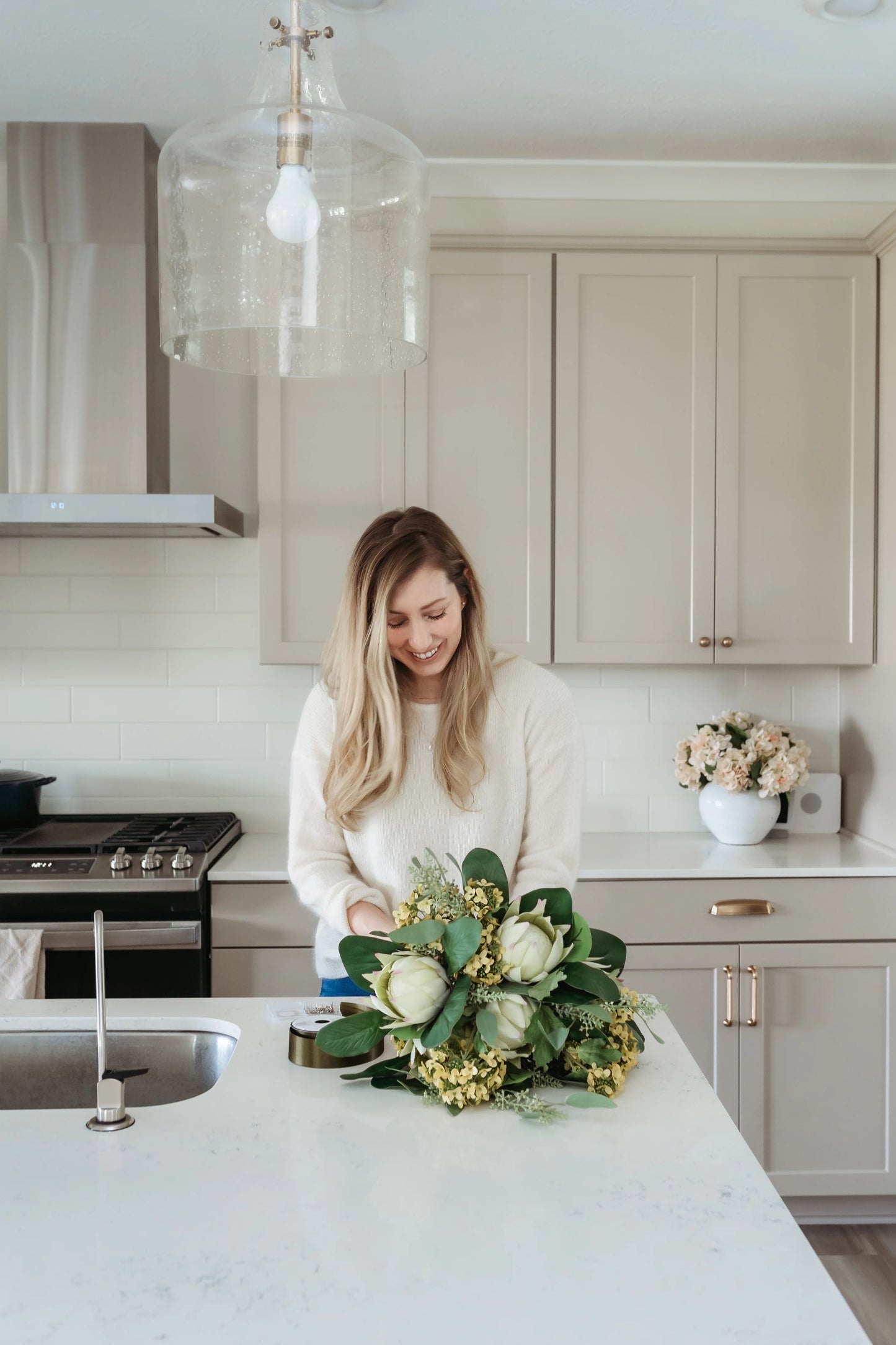 Devon Wellington assembling summer bouquet including king protea flower.