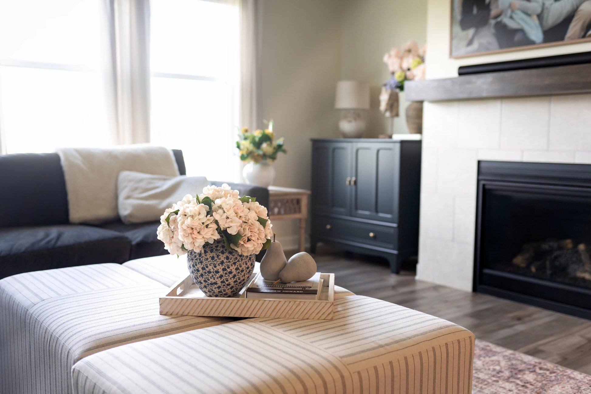 Blue ceramic vase featuring floral decal and real touch hydrangea florals.