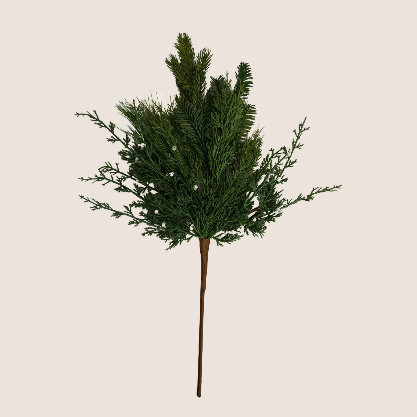 Single stem of mixed evergreen artificial stem featuring mix of juniper, cedar, balsam fir, and ponderosa pine against blush background. 