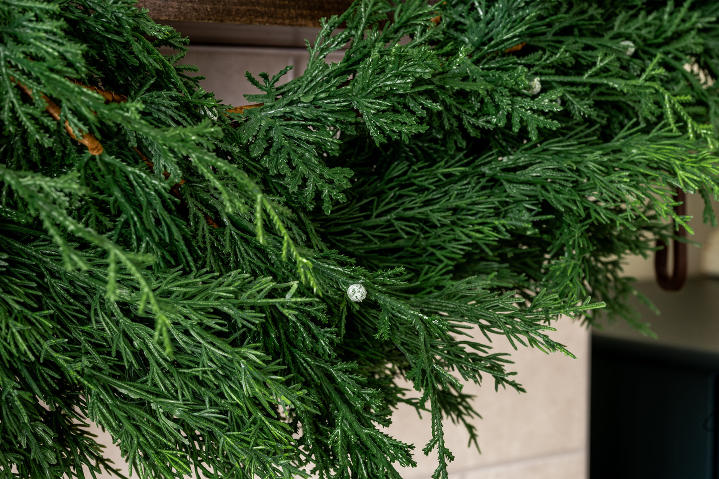 Winter berry juniper garland close up featuring mixed greenery and berry look for holiday decorating.