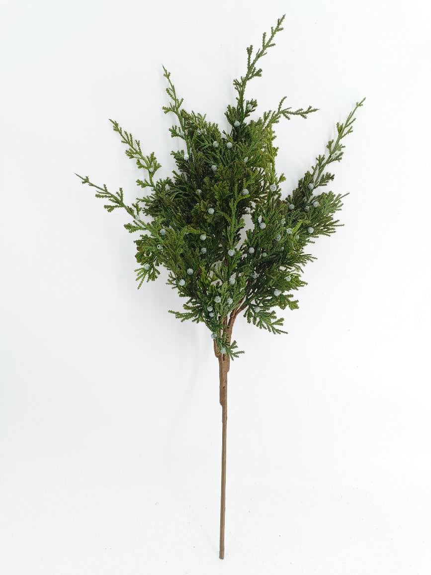 Artificial juniper greenery branch for holiday decorating featuring lifelike greenery and white berries with a greenish-blue undertone. 