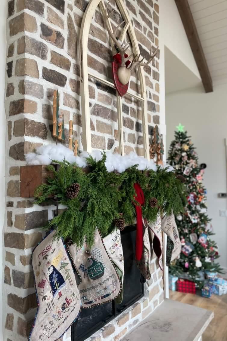 Artificial cedar holiday garland on Christmas mantle. 