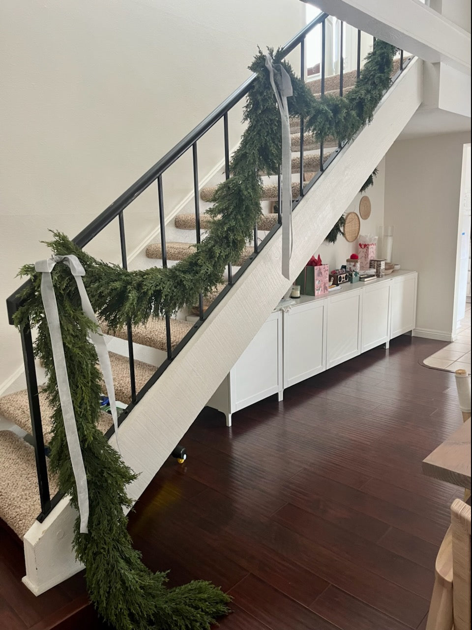 9 foot artificial cedar garland on stair case in California style home for the holiday. 