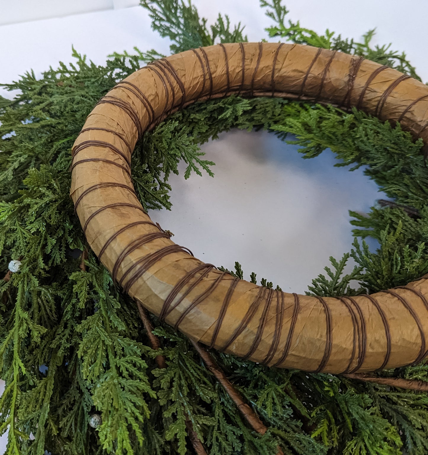 Backing for artificial cypress-juniper berry wreath.