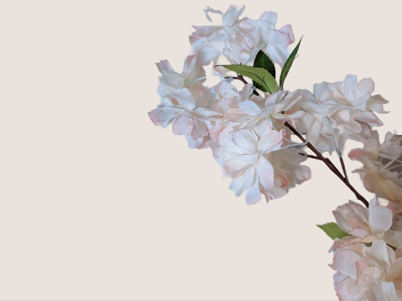 Close-up image of artificial waterfall cherry blossom blooms in soft pink and white with fully opened petals, arranged in a cascading pattern to mimic a waterfall effect. The brown stem, which is 16 inches long, is highly detailed with lifelike texture. Each stem has three branches, and the total height of the image is 38 inches, with 22 inches of blossoms/branches. The image is set against a neutral beige background.